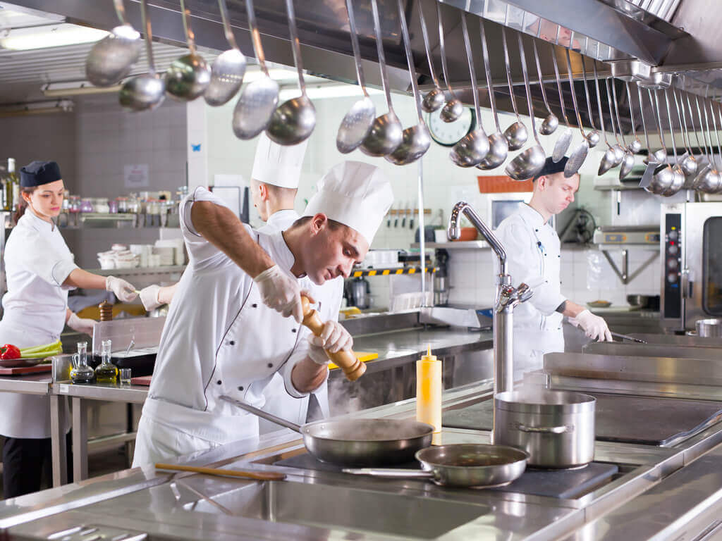 chefs and cooks in industrial kitchen