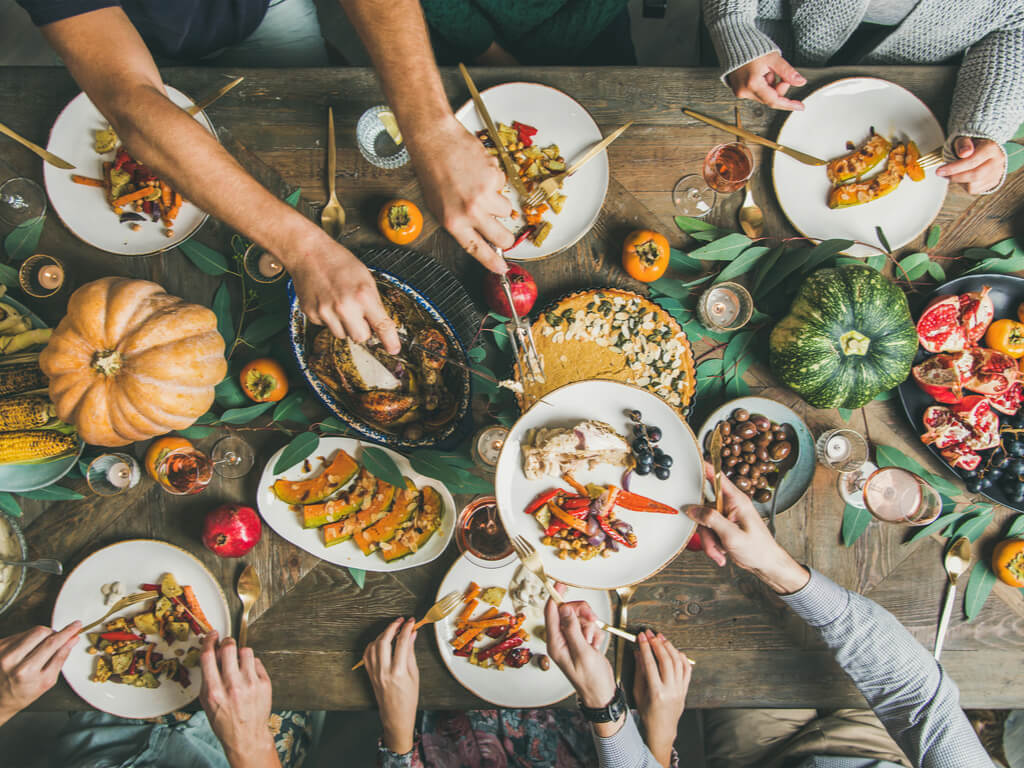 a group of friends sharing a thanksgiving meal